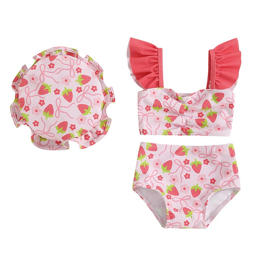 Three-piece infant and toddler girl swimwear set featuring a pink strawberry print ruffle tankini top, high-waist shorts, and matching sun hat.
