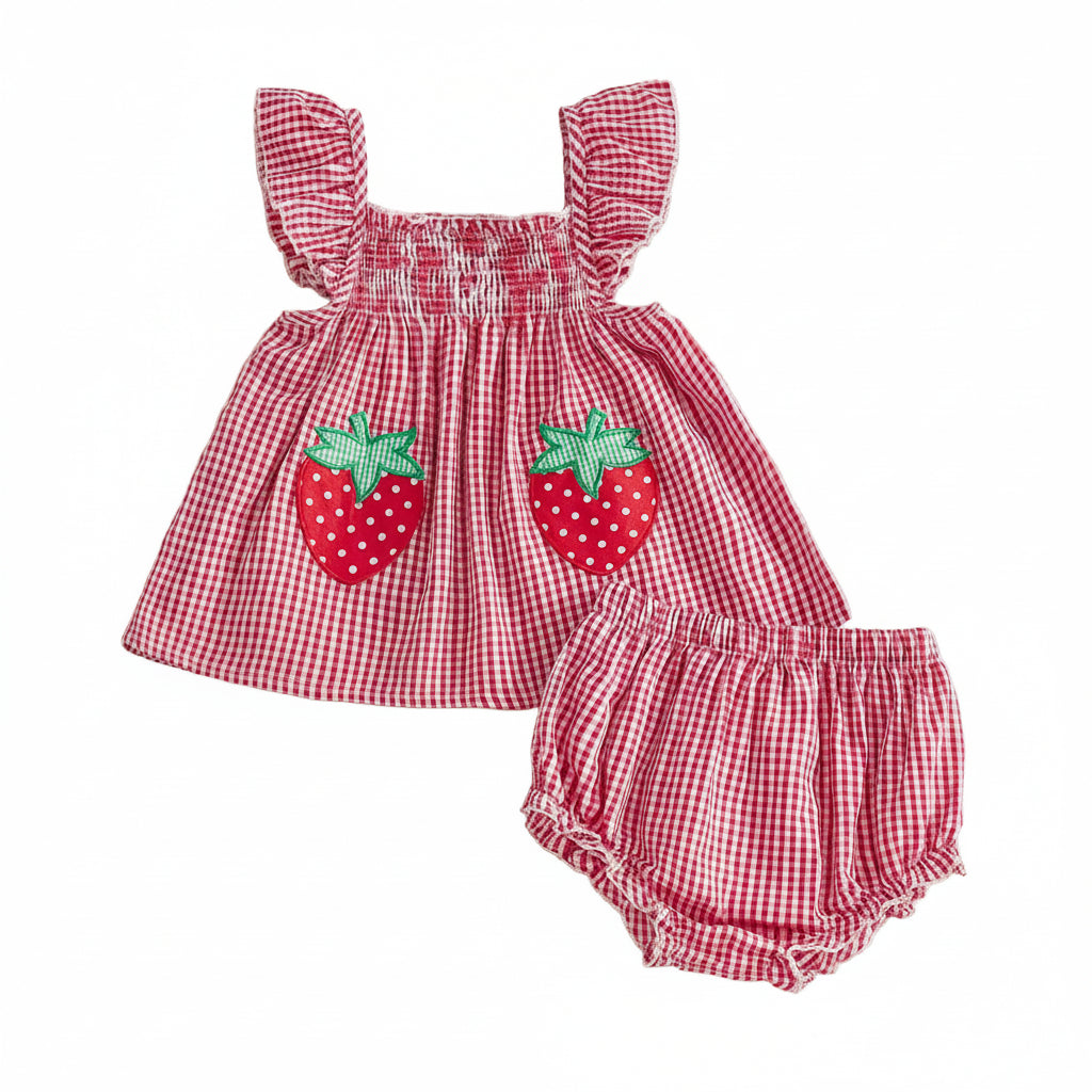Front flat lay view of a baby girl 2-piece summer outfit featuring a red and white gingham smocked tunic top with two embroidered strawberry patches and matching ruffled bloomers.