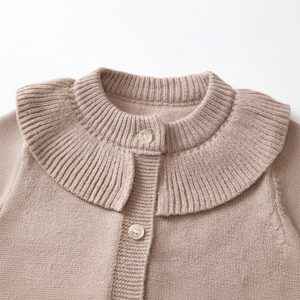 Flat lay arrangement of a taupe baby girl knit cardigan with a button-front closure and ruffled collar.