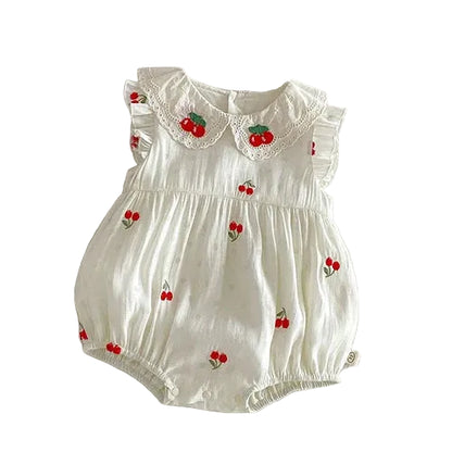 Front view of a baby girl vintage cherry embroidered bubble romper in antique cream cotton muslin on a clean white background.