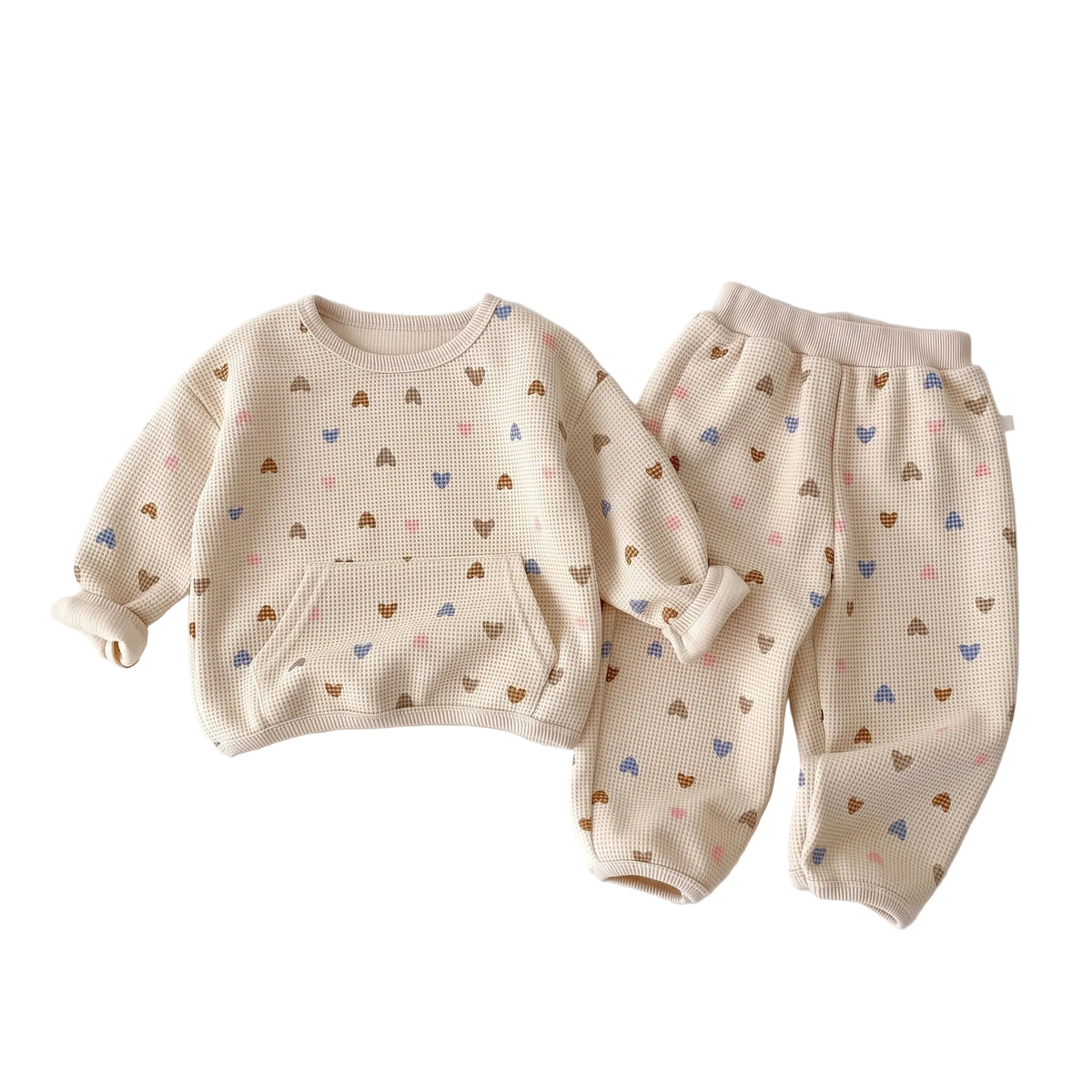Toddler baby girl waffle knit sweatshirt and jogger pants set with colorful heart print against a white background