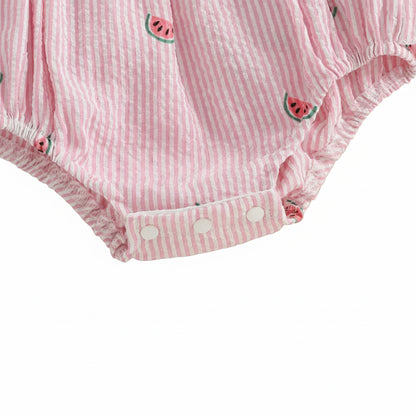 Close-up of the bottom opening of the romper, showing the reinforced snap closures for diaper changes.