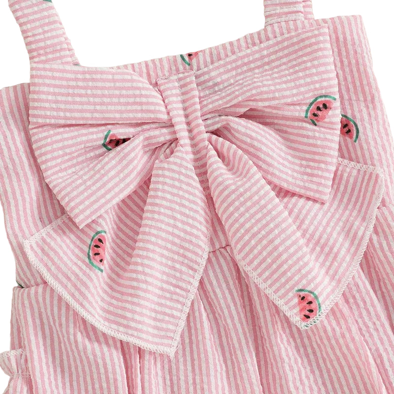 Close-up detail of the bodice on the baby girl watermelon romper, focusing on the large front bow and seersucker fabric texture.