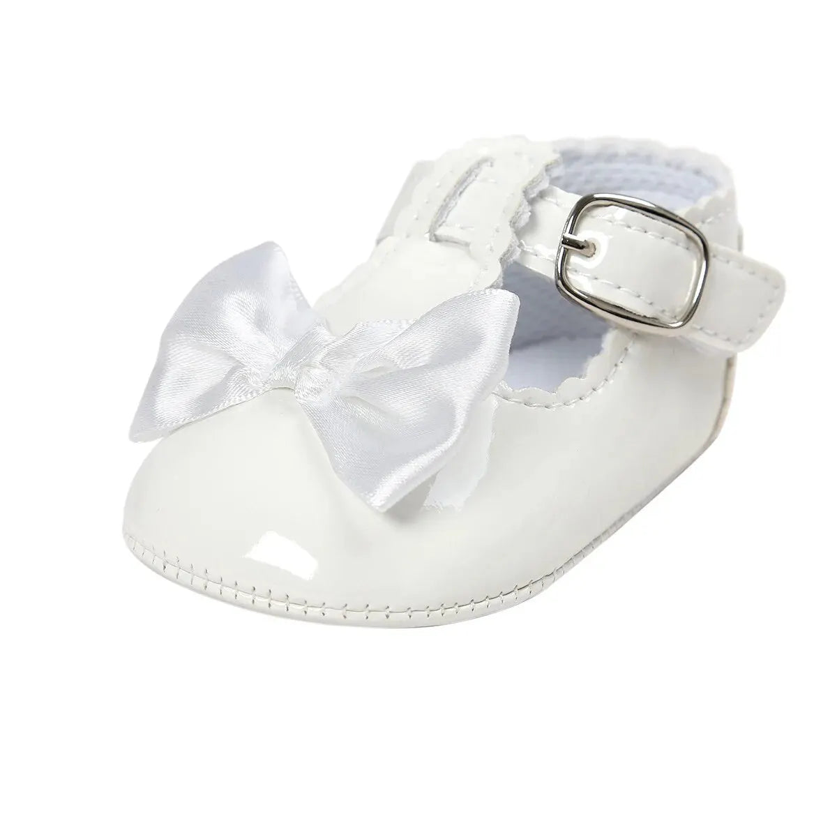 Side angle view of a single baby girl white patent leather T-strap Mary Jane dress shoe featuring a clean white satin ribbon bow.