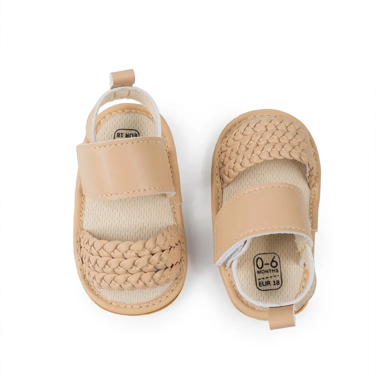 Top-down view of beige baby girl woven faux leather sandals with velcro straps.