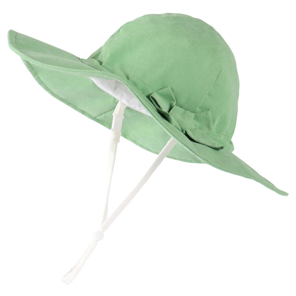 Pastel green 100% cotton wide brim sun hat for baby girls featuring an adjustable chin strap and side bow.