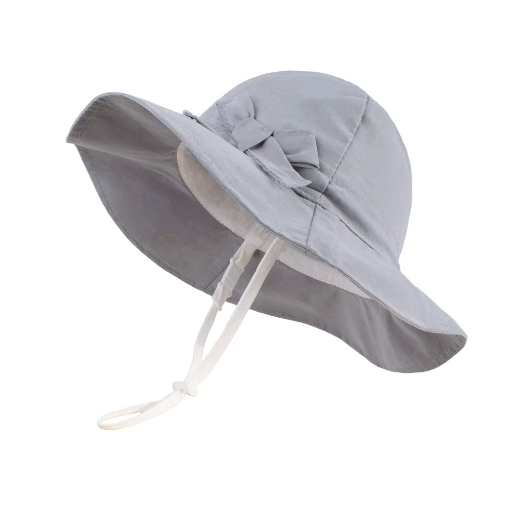 Classic grey 100% cotton wide brim sun hat for toddler girls with a secure toggle chin strap and bow.