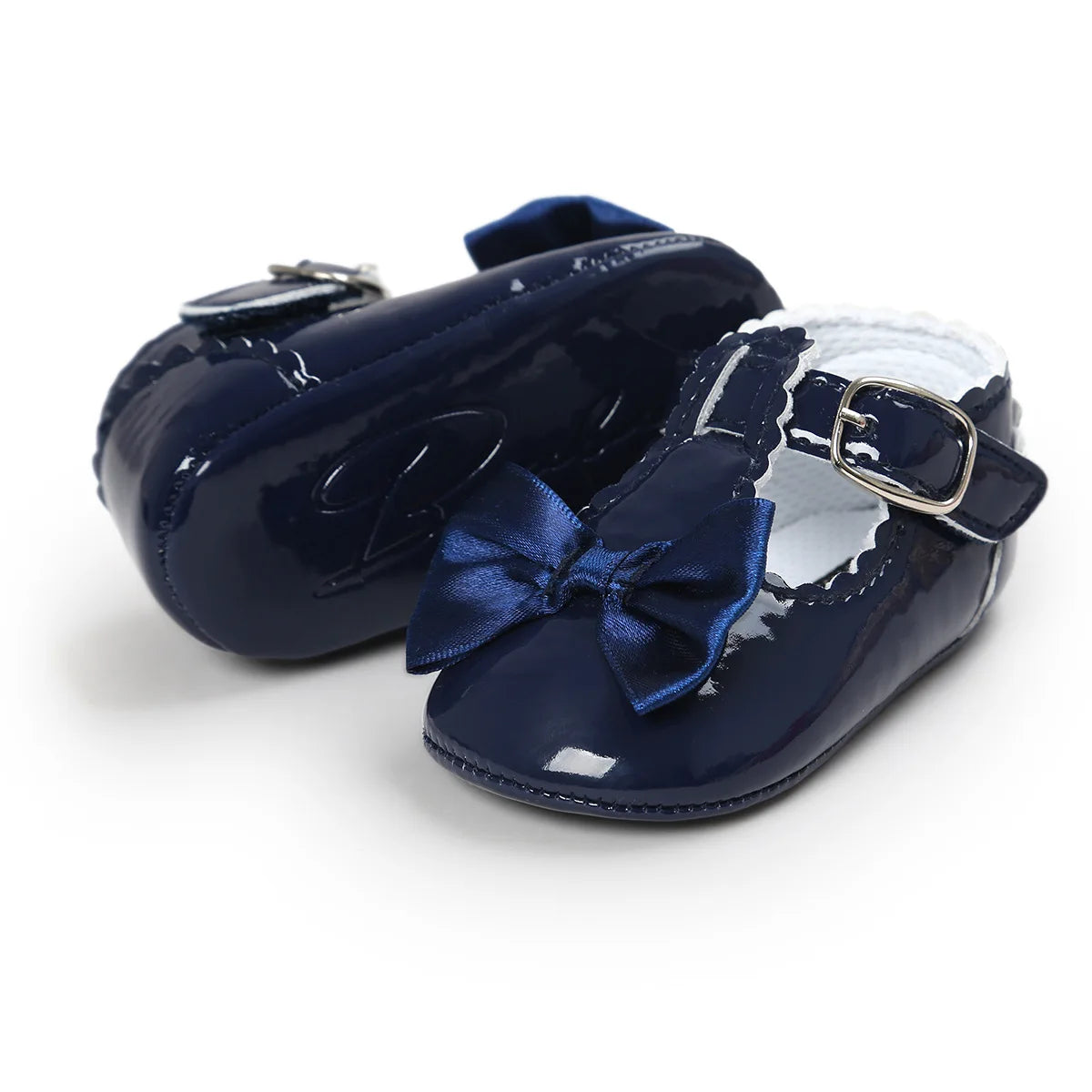 Deep navy blue patent leather baby girl T-strap Mary Jane dress shoes featuring a dark blue satin bowknot overlay.