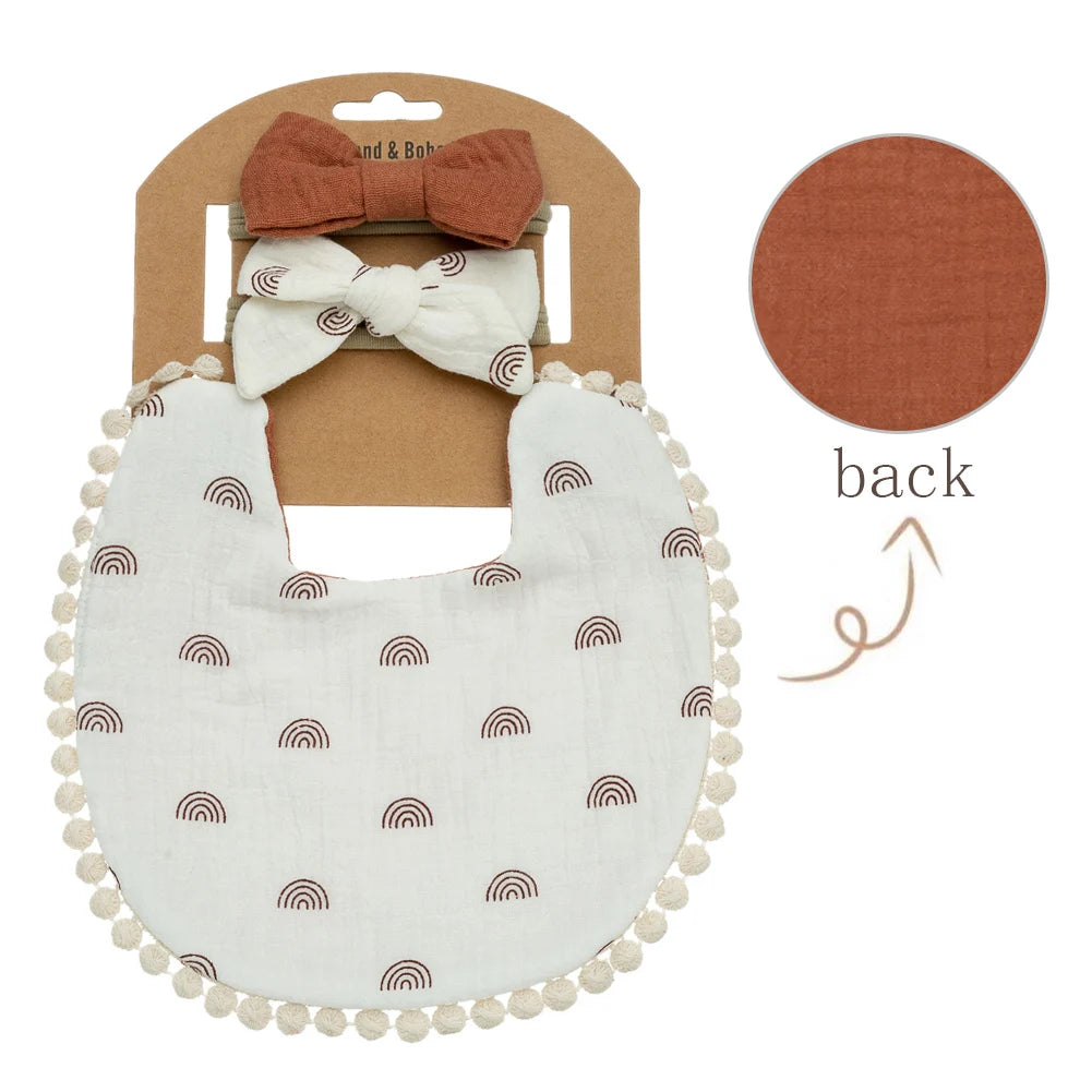 Boho rainbow print double-gauze muslin baby girl bib with rust brown matching bow headbands.