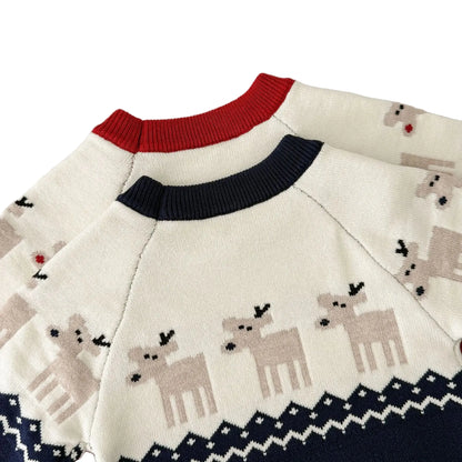 Close-up showing the detailed knit stitching and reindeer motif on the back of the baby holiday rompers.