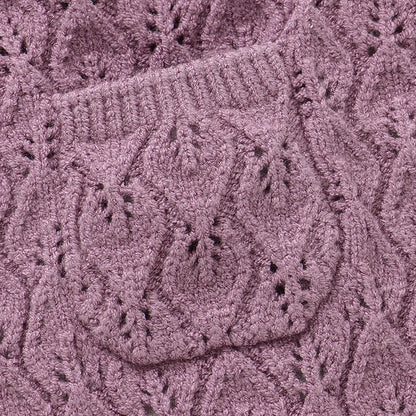 Close-up of the delicate pointelle knit pattern and center front pocket on a mauve baby sweater romper.