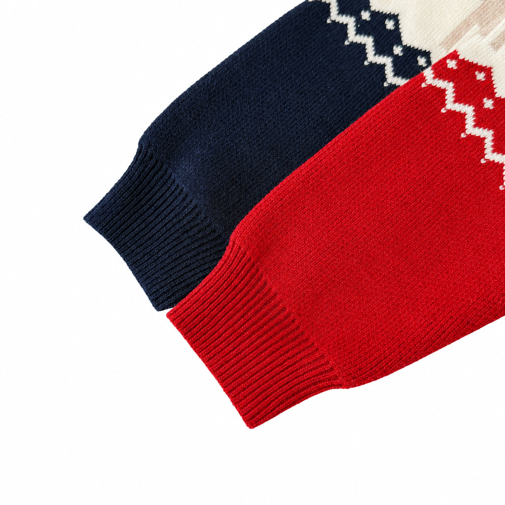 Close-up of the ribbed long-sleeve cuffs on the navy and red baby Christmas rompers.