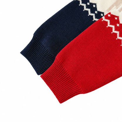 Close-up of the ribbed long-sleeve cuffs on the navy and red baby Christmas rompers.