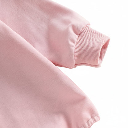 Close-up of the long sleeve and stretch ribbed wrist cuff on the pink infant golf romper.