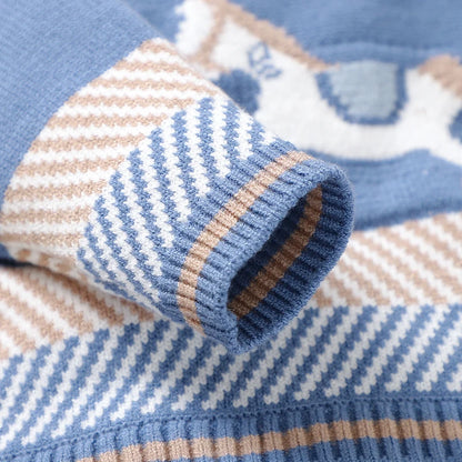 Detailed close-up of the long sleeve and elastic ribbed cuff with beige and white chevron stripes on the knit baby coverall.