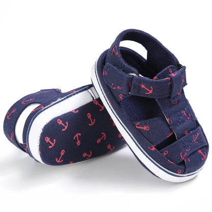Side profile view of a pair of navy blue nautical baby canvas boat shoes.