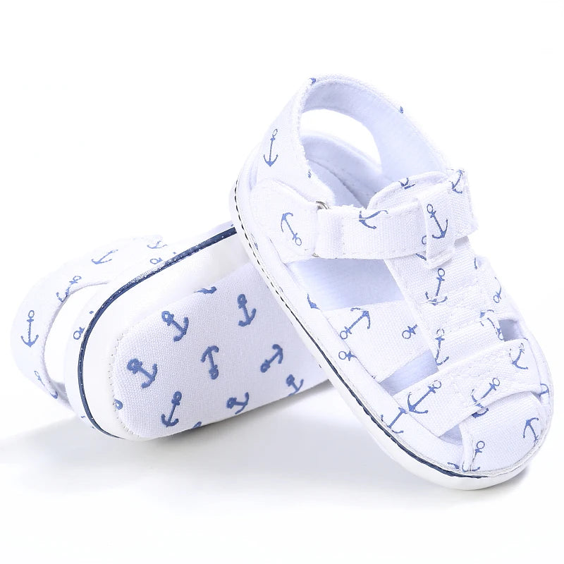 Side profile view of a pair of white nautical baby canvas boat shoes.