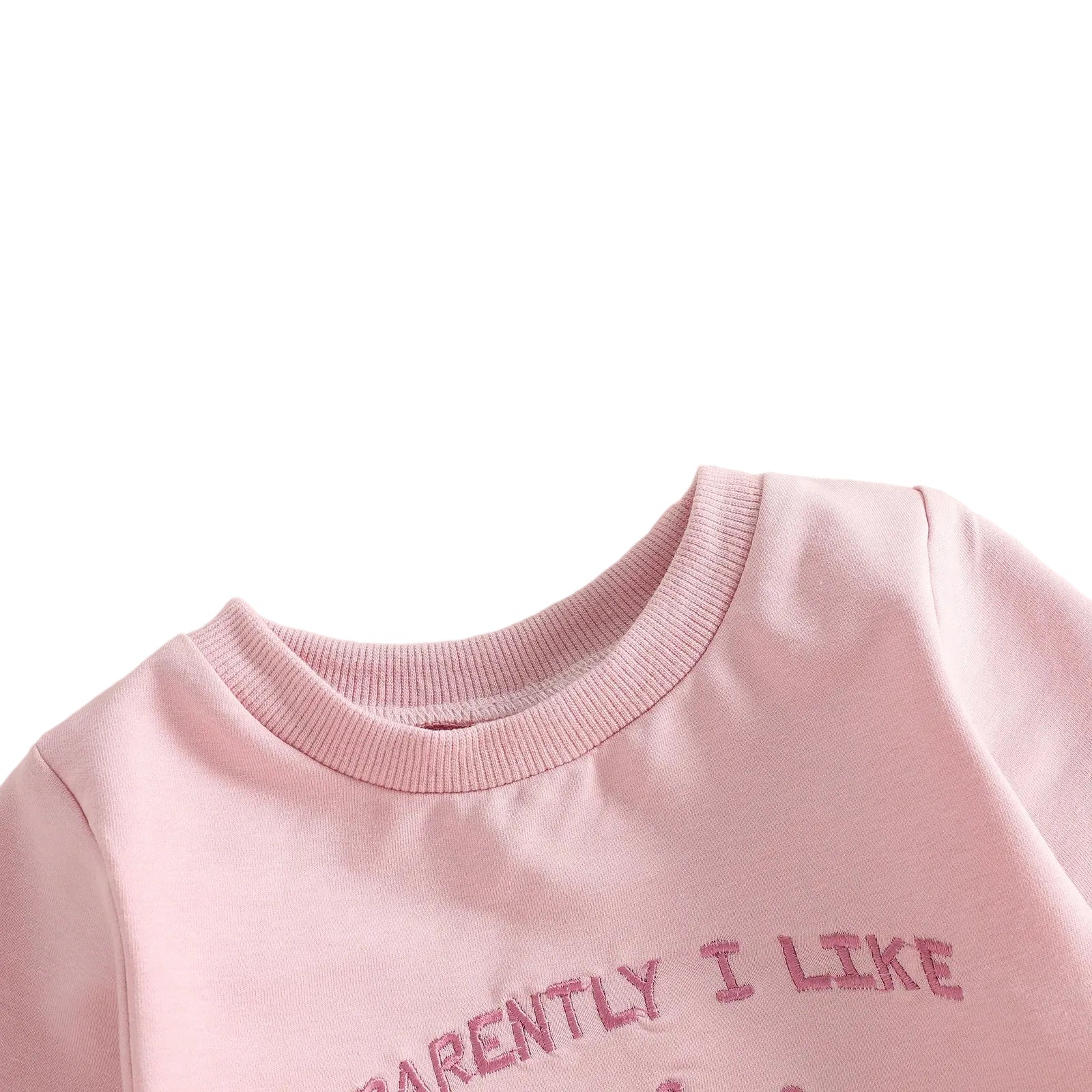 Close-up showing the soft ribbed crew neckline on the baby girl pink long-sleeve golf romper.