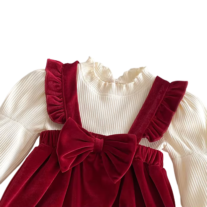 Close-up shot of prominent front bow, strap ruffles, and cream ribbed ruffled collar.
