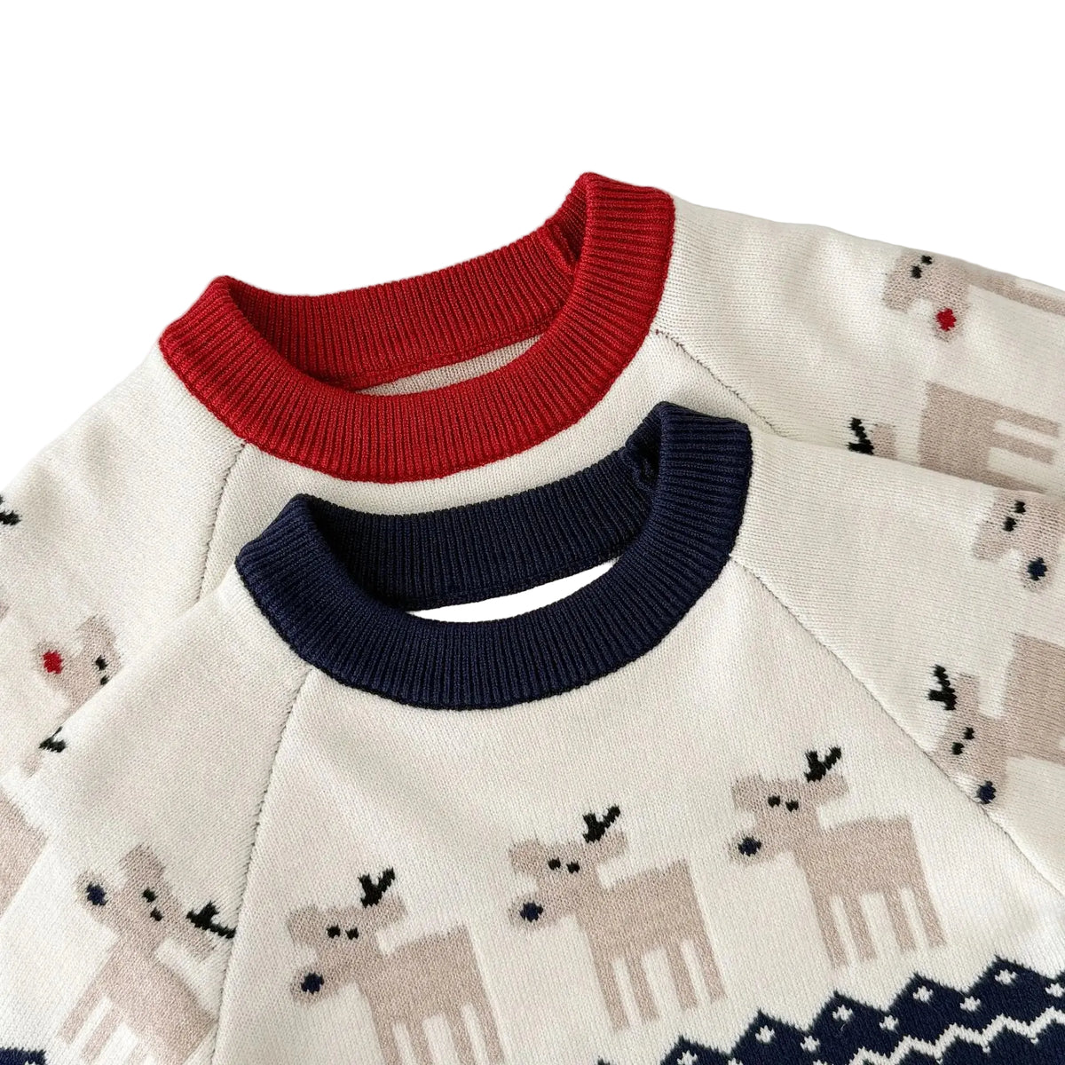 Close-up of the neckline and reindeer knit pattern on the red and navy baby winter rompers.