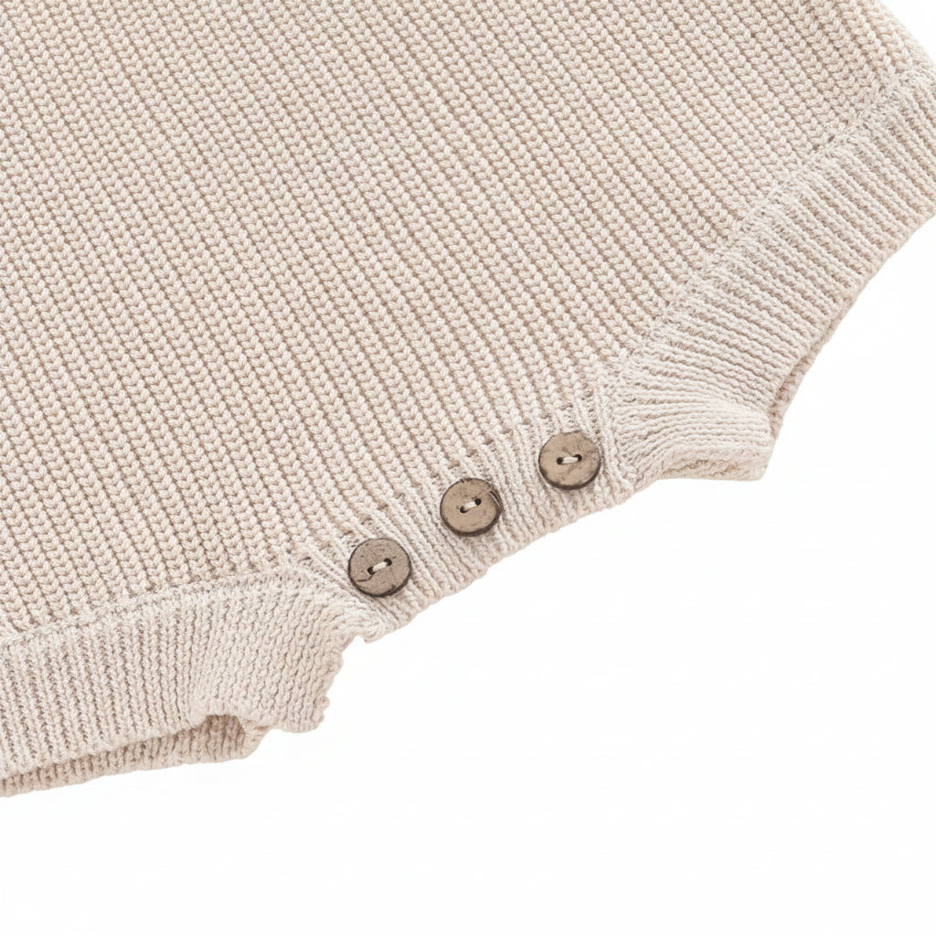 Detailed close-up of the sturdy bottom button closures on the crotch opening for easy diaper changes.