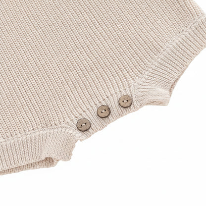 Detailed close-up of the sturdy bottom button closures on the crotch opening for easy diaper changes.