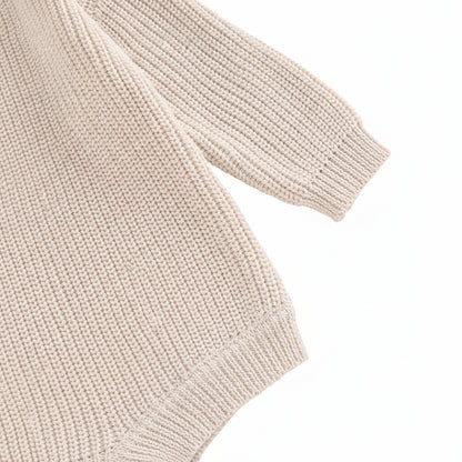 Close-up of the long sleeve cuff and smooth shoulder seam construction on the soft cotton blend knit romper.