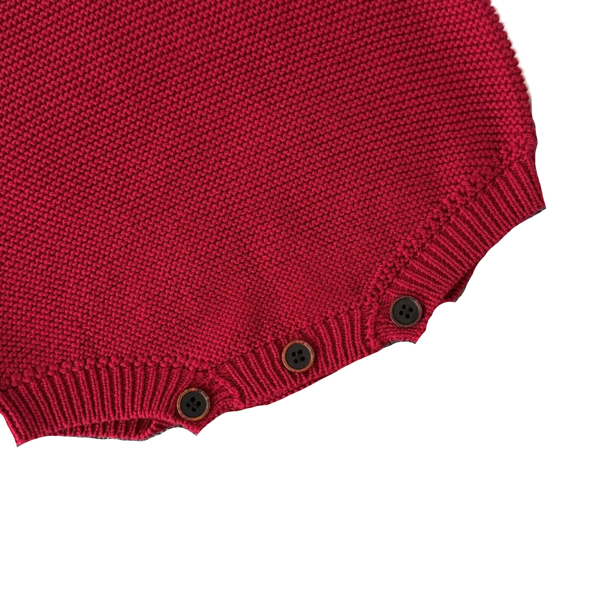 Close-up of the secure bottom button snap closures on the red knit material of the baby boy romper.