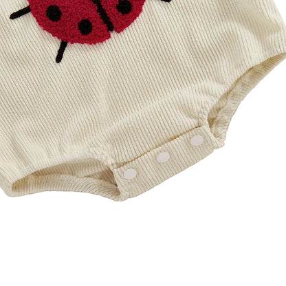 Close-up of the reinforced bottom snap closures for easy diaper changes on the Nature Collection rompers.