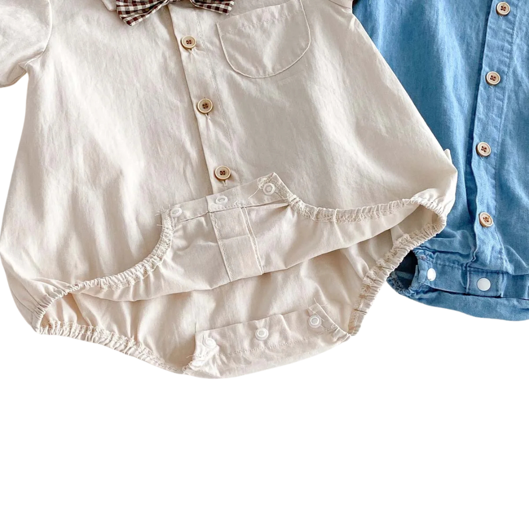 Close-up view of the baby romper with crotch snaps open to show easy diaper change access and reinforced stitching.