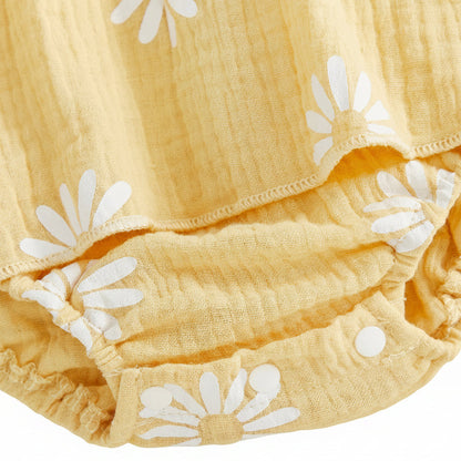 Close-up view of the convenient bottom diaper snap buttons on the ruffled yellow daisy baby bodysuit.