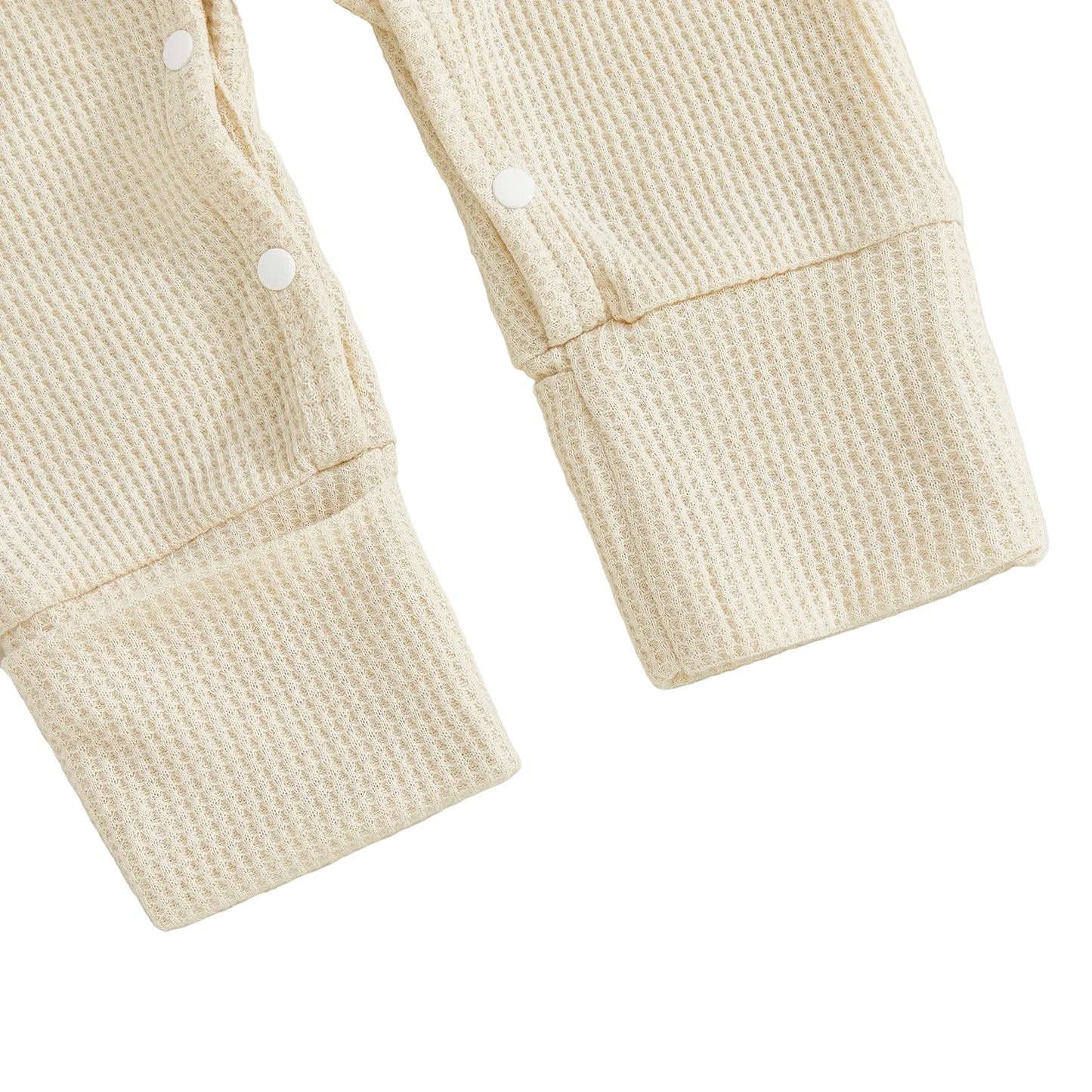 Close-up of the ribbed cuffs and secure snap closures on the legs of the beige waffle knit baby romper.