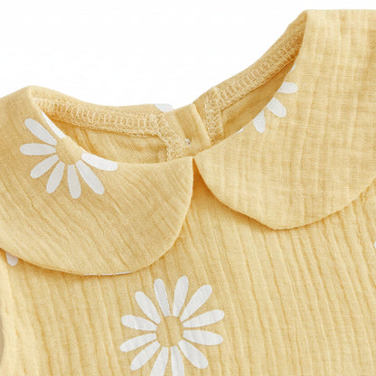 Close-up detail of the classic rounded Peter Pan doll collar on the yellow cotton daisy print baby romper.