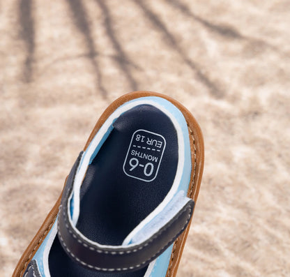 Close-up of the smooth inner lining and size tag on a blue baby sandal.