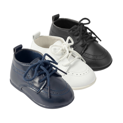 Group shot of Kidsely smooth faux leather baby brogue oxford dress shoes in navy blue, white, and black with lace-up closures.