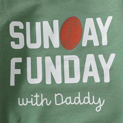 Close-up detail of the screen-printed white typography design and classic brown football illustration on the front of the infant jumpsuit.