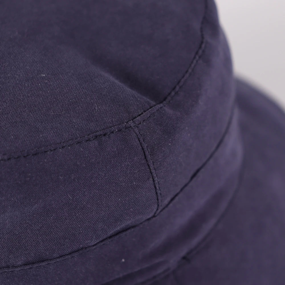 Close up of the UV protection exterior fabric and stitching on the dark blue toddler bucket hat.