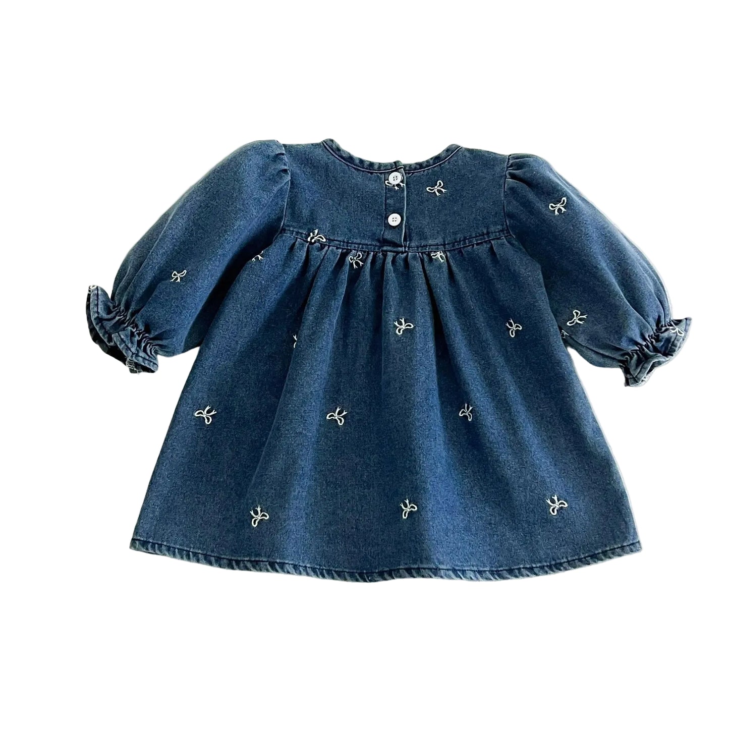 Back view of the baby and toddler girl blue denim smock dress showing the relaxed A-line cut and back button.
