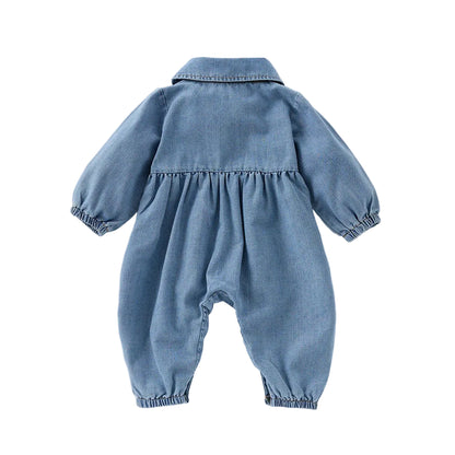 Full back view of a blue denim long-sleeve playsuit for baby and toddler girls, highlighting the gathered waistline.