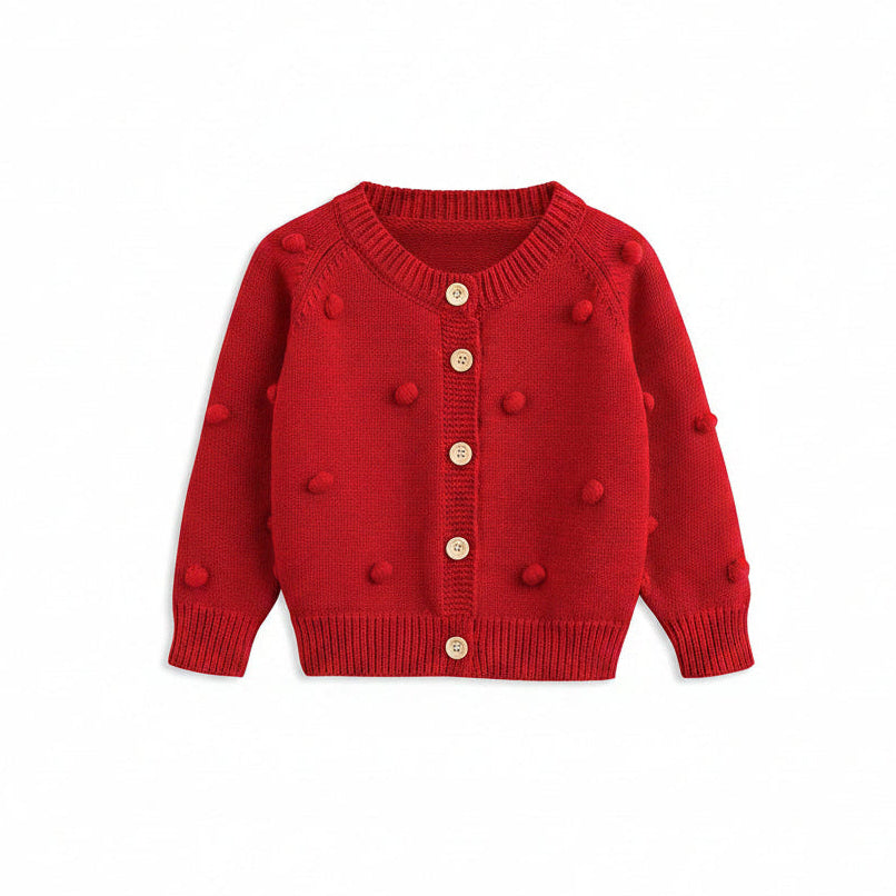 Front view of the baby and toddler girls red cotton knit cardigan featuring 3D pom-poms and wooden buttons.