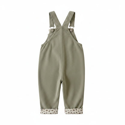 Back view of baby and toddler girls sage green corduroy overalls featuring adjustable suspender straps.