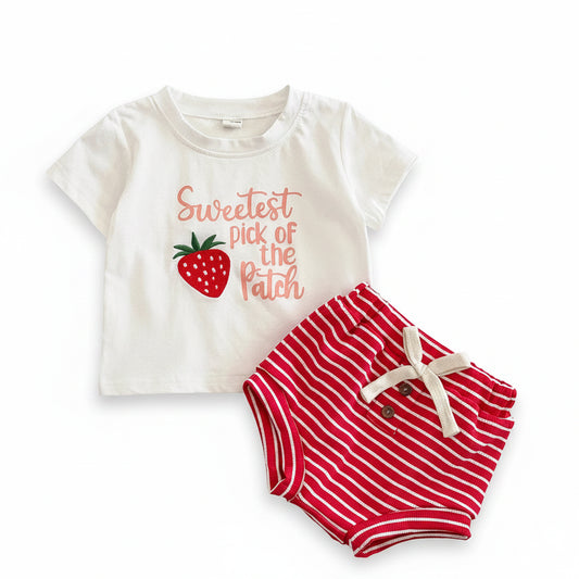 Baby and toddler girls white short sleeve T-shirt with Sweetest Pick of the Patch strawberry graphic and red and white striped ribbed shorts.