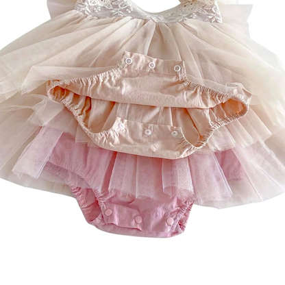 Built-in bodysuit and snap button crotch closure on pink and cream baby tutu dress