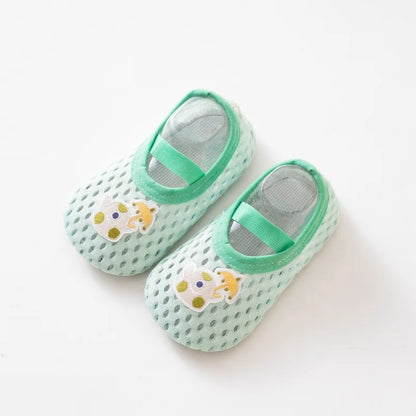 Mint green baby water shoes with a whimsical teapot patch and breathable mesh upper.