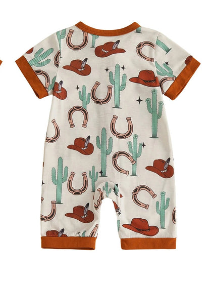 Back view of a cream infant short sleeve zip-up romper with a desert cactus, cowboy hat, and horseshoe pattern.