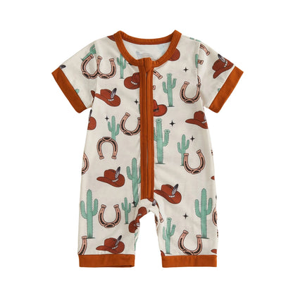 Front view of a cream infant short sleeve zip-up romper featuring a desert cactus, horseshoe, and brown cowboy hat pattern.