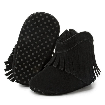Black baby western fringe moccasin booties displaying the anti-slip flexible soft sole on a white background.