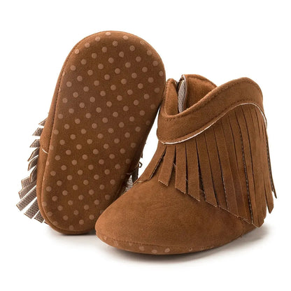 Side view of classic brown infant fringe suede moccasin booties with zipper detailing on a white background.