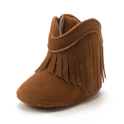 Pair of deep tan chestnut infant fringe suede moccasin booties, front angle view on a white background.