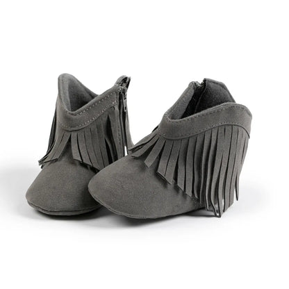 Pair of gray infant fringe suede moccasin booties, front view on a white background.